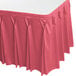 A dusty rose Snap Drape table skirt with bow tie pleats on a table.