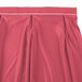 A dusty rose table skirt with a white stripe at the hem.