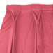 A Snap Drape dusty rose table skirt with bow tie pleats.