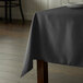 A table with a black tablecloth on it.