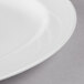 A close up of a white Libbey porcelain platter with a white rim.
