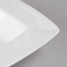 A close-up of a white rectangular porcelain bowl with a white rim.