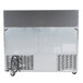 A grey Traulsen refrigerated sandwich prep table with metal rectangular doors and white text.