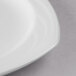 A close up of a Libbey Royal Rideau white porcelain plate with a white rim.