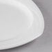 A close up of a Libbey Royal Rideau white porcelain plate with a small rim.