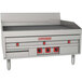 A MagiKitch'n electric countertop griddle with thermostatic controls and metal surface with knobs.