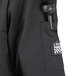 A close-up of the back pocket on a black Chef Revival short sleeve chef coat.