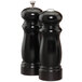 Two black Chef Specialties Salem ebony finish pepper mills on a counter.