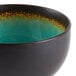 A close-up of a green and black Libbey Hakone stoneware bowl.