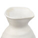 A white stoneware Libbey sake bottle with a handle.