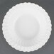 A white plastic bowl with a scalloped edge.