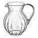 A clear plastic pitcher with a handle.