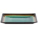 A Libbey stoneware rectangular platter with a green and black rim.