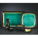 A Libbey stoneware platter with a green and black rim.