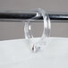 A clear plastic ring on a Bobrick white vinyl shower curtain.