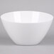 An American Metalcraft white melamine bowl with a white rim on a grey surface.