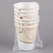 A stack of Solo white foam cups with brown wrapping.