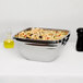 A Vollrath double wall square metal bowl with pasta inside.