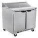 A Beverage-Air stainless steel refrigerated sandwich prep table with two doors on wheels.