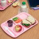 A left handed Carlisle variegated 6 compartment tray with a sandwich, apple, and juice on it.