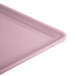 A close-up of a pink Cambro dietary tray.