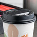 A Solo black plastic lid on a coffee cup.