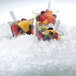 A group of fruit cups in ice with a bowl of fruit.
