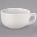 A Tuxton eggshell white china cappuccino cup with a handle.