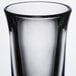 A clear Libbey tall shot glass with a black rim.