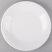 A white Fiesta dinner plate with a white rim on a gray surface.