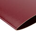 A burgundy leather Menu Solutions wine list cover with gold trim.