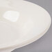 A close-up of a Homer Laughlin ivory china soup bowl with a rolled edge.