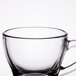 A close-up of a Libbey clear glass espresso cup with a handle.