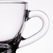 A close up of a clear Libbey glass espresso cup with a handle.