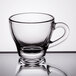 A Libbey clear glass espresso cup with handle.