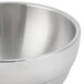A close-up of a Vollrath stainless steel serving bowl.