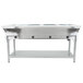 An Eagle Group stainless steel open well electric hot food table on a counter with four pans.