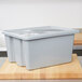 A Rubbermaid gray plastic tote box lid on a plastic container.