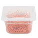 A translucent plastic container lid with a handle over a plastic container with carrots inside.