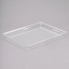 A clear plastic tray with Cal-Mil 325-10-12 Shallow Clear Bakery Tray on a white surface.