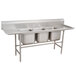 A stainless steel Advance Tabco three compartment pot sink with two drainboards.