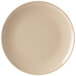 A close-up of a beige round bamboo melamine plate.