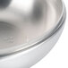 A close-up of a silver Vollrath stir fry domed cover on a white background.