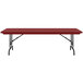 A red rectangular Correll folding table with black legs.