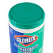 A green and white Clorox container of disinfectant wipes with a blue lid.