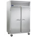 A large silver Traulsen pass-through refrigerator with two doors.