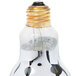 A close up of a Nemco 6008-4 countertop heat lamp bulb with a gold metal cap.