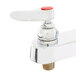 A chrome T&S deck-mounted workboard faucet with red handles and a swivel gooseneck spout.