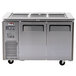 A stainless steel Turbo Air refrigerated buffet display table with two doors on a counter.