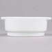 An Arcoroc white porcelain soup bowl with a handle on a white background.